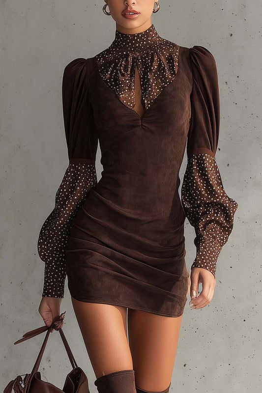 Brown dress with sheer sleeves and collar against a gray background