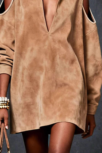 Brown suede dress worn by a person on a dark background