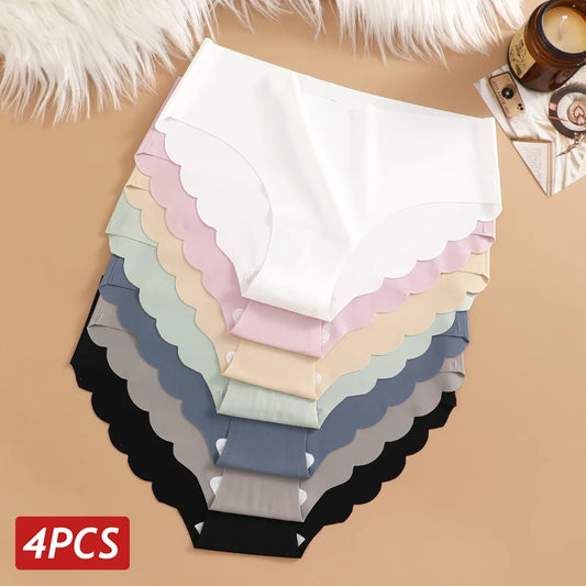 Set of four pairs of women's underwear in various colors on a beige surface.