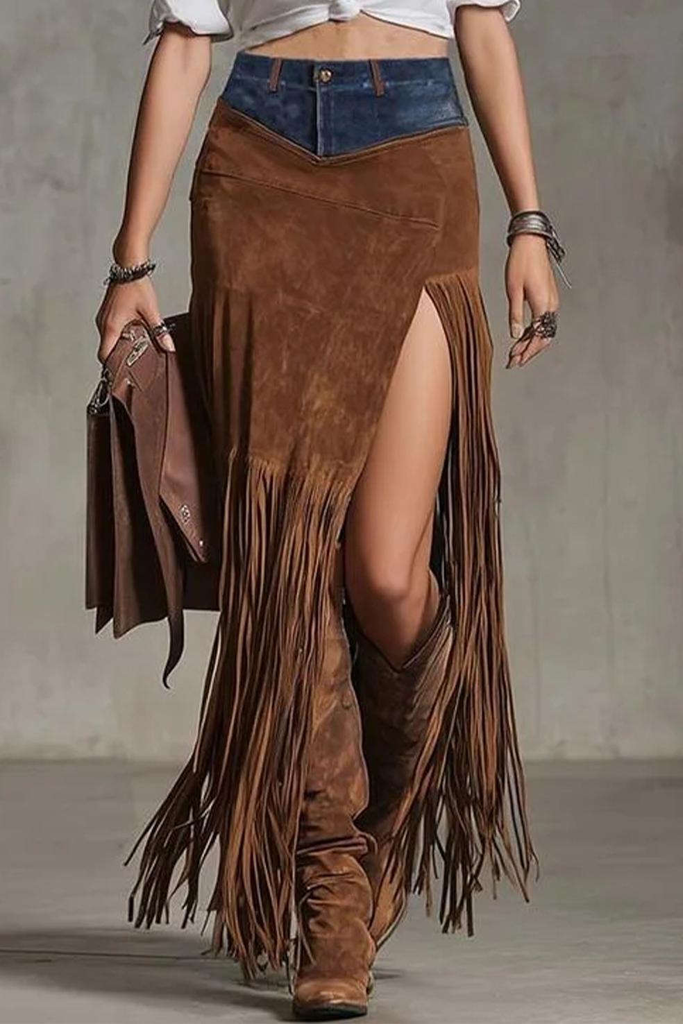 Person wearing a brown suede fringe skirt with a plain background