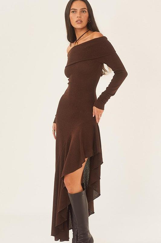 Woman wearing a brown off-shoulder dress with long sleeves on a white background