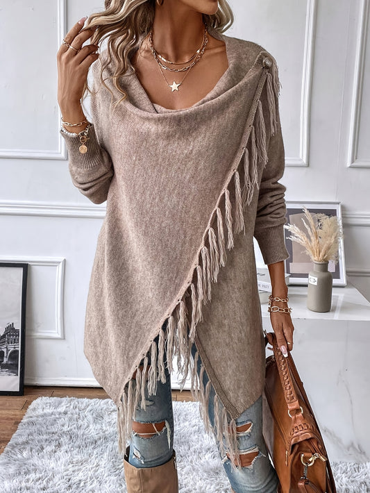 Woman wearing a beige fringe sweater in a room with decor elements.