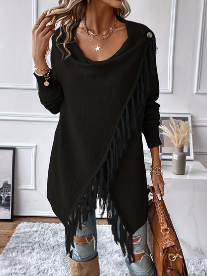 Person wearing a black fringe sweater with ripped jeans and holding a brown bag in an indoor setting.