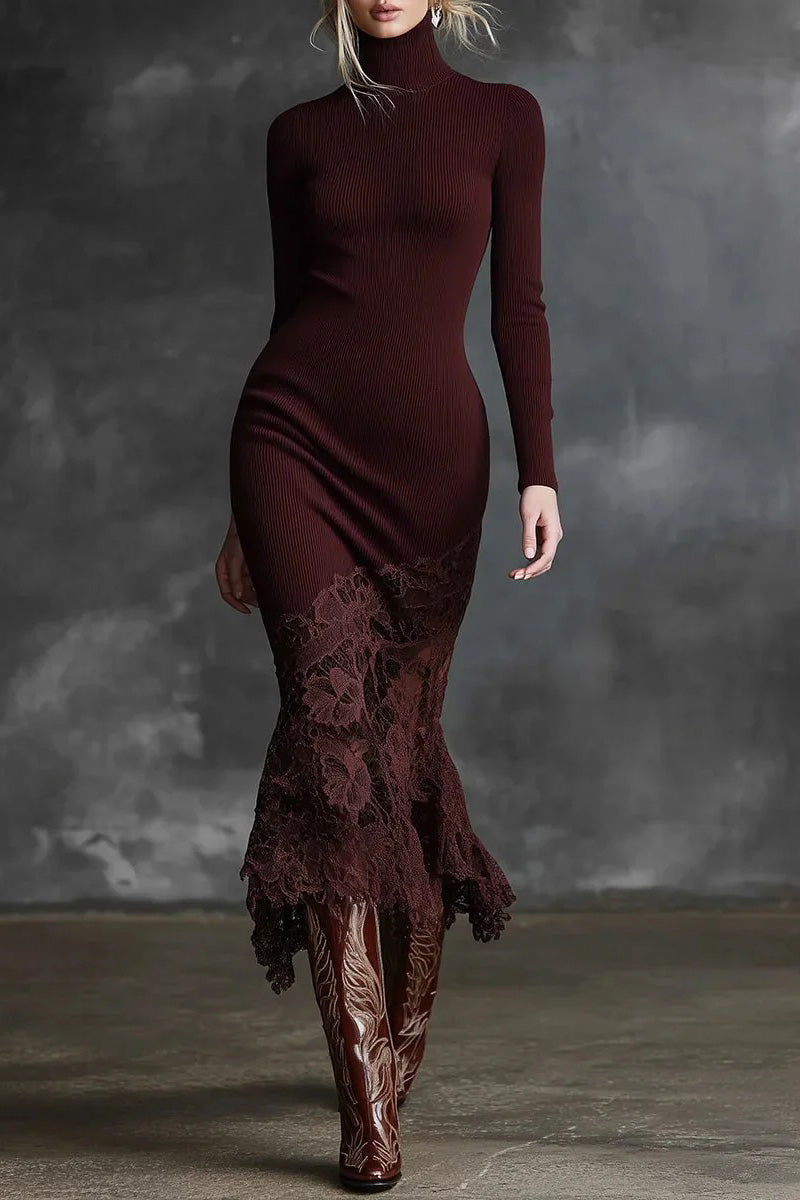 Woman wearing a burgundy dress with lace detailing and matching boots against a gray background