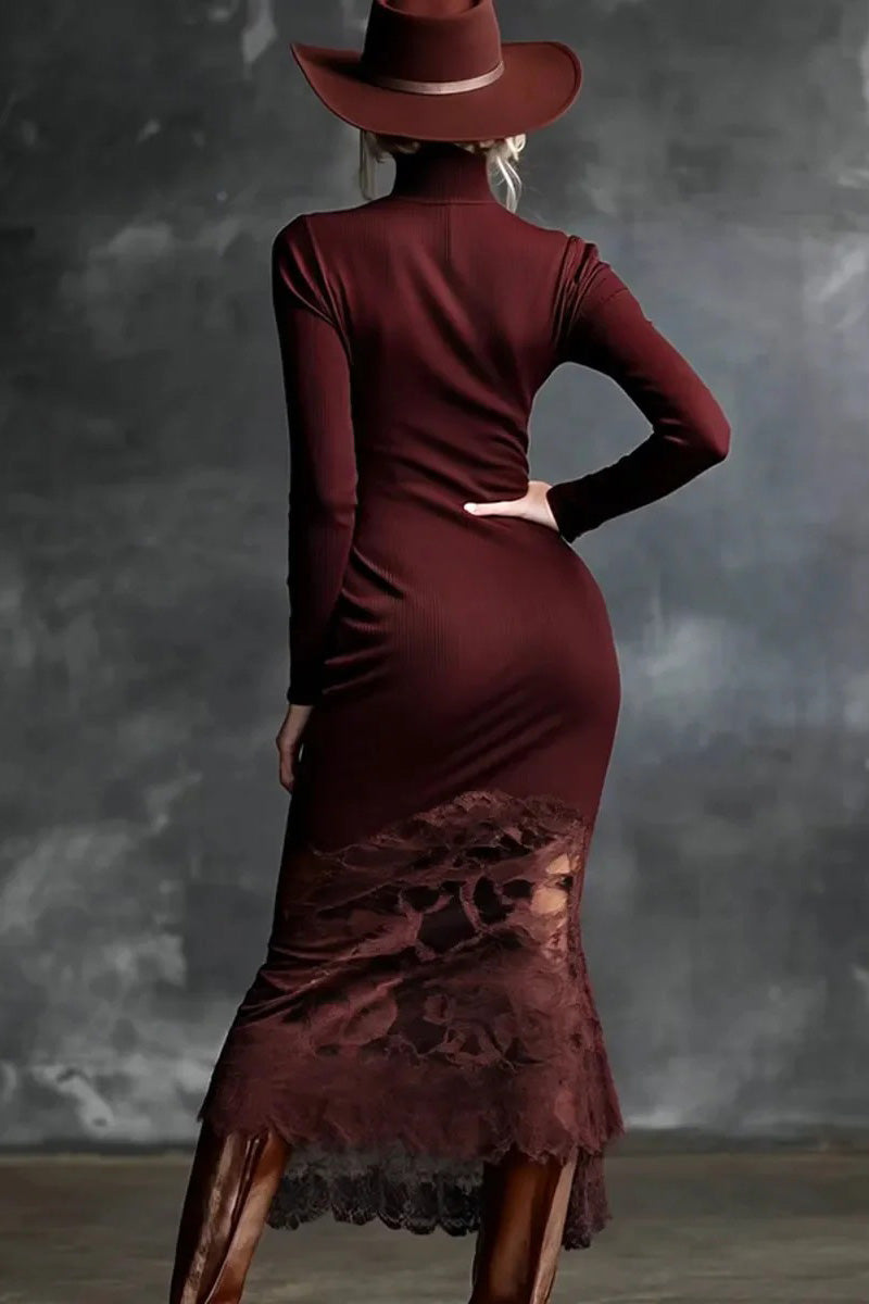 Person wearing a burgundy dress with lace detailing and a matching hat against a gray background